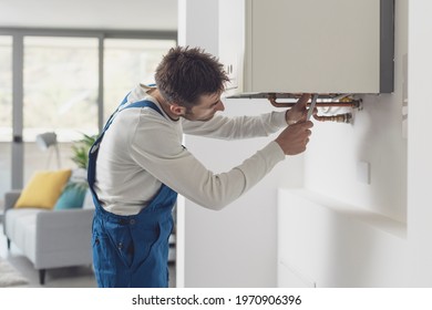 Professional Plumber Checking A Boiler And Pipes, Boiler Service Concept