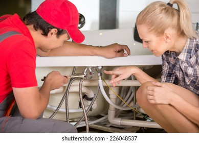 Professional Plumber. Plumbing Repair Service. Woman Is Showing Damage Plumbing.