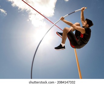 Professional pole vaulter training at the stadium. Copy space background - Powered by Shutterstock