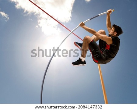 Professional pole vaulter training at the stadium. Copy space background