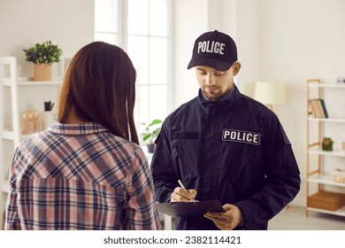 Professional policeman interrogates witness, victim or suspect of crime. Officer working on burglary, felony or murder case, asking young woman questions and taking notes. Police investigation concept