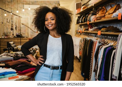 Professional portrait of a young beautiful owner of dress shop at entrance of commercial activity - Millennial starts a new start-up activities in her city - Sales assistant waits for customers - Shutterstock ID 1952565520