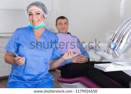 professional positive doctor woman and patient sitting in medical chair