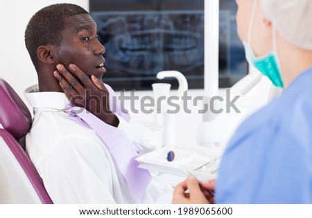 Professional positive doctor woman talking with patient in medical chair. High quality photo