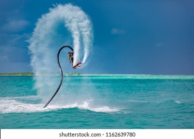 Professional pro fly board rider in tropical sea, water sports concept background. Summer vacation fun outdoor sport