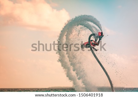 Professional pro fly board rider in tropical sea, water sports concept background. Summer vacation fun outdoor sport and recreation