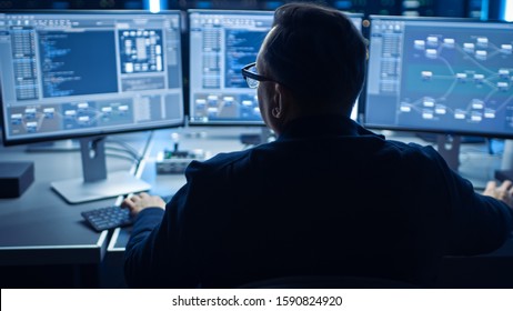 Professional IT Programer Working in Data Center on Desktop Computer with Three Displays, Doing Development of Software and Hardware. Displays Show Blockchain, Data Network Architecture Concept