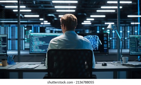 Professional IT Programer Working in Data Center on Desktop Computer with Two Displays, Doing Development of Software and Hardware. Displays Show Blockchain. Data Network Architecture Concept - Powered by Shutterstock