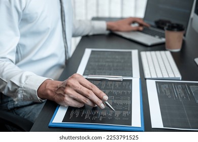Professional programmer working on website project in software development on the desktop computer, making coding and typing data code password security.