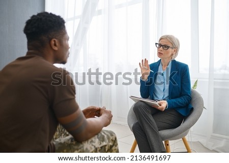 Professional psychologist giving advice to military patient