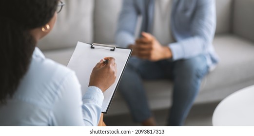 Professional psychotherapy. Female psychologist having session with young male patient at mental health clinic, selective focus. Banner design with copy space. Treatment of depression concept - Shutterstock ID 2093817313