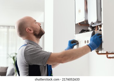 Professional Qualified Engineer Testing A Gas Boiler After Repair