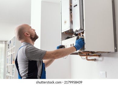 Professional Qualified Engineer Testing A Gas Boiler After Repair