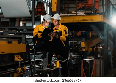 Professional quality control inspector conduct safety inspection on steel machinery and manufacturing process. Factory engineer or operator make optimization in heavy industry facility. Exemplifying - Powered by Shutterstock