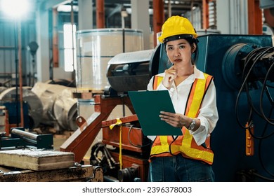 Professional quality control inspector conduct safety inspection on machinery and manufacturing process in factory. Female engineer overseeing process optimization in mechanical facility. Exemplifying - Shutterstock ID 2396378003