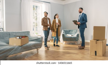 Professional Real Estate Agent Shows Bright New Apartment to a Young Couple. Successful Young Couple Ready to Become Homeowners. Spacious Bright Home with Big Windows. - Shutterstock ID 1436511665