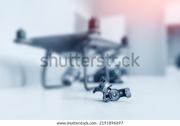 Professional repair of RC\
drones and radio controlled cars, robots.Broken quadrocopter lies\
on desktop.