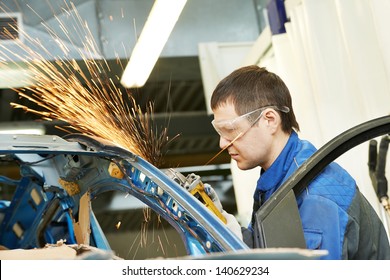 professional repairman worker in automotive industry grinding metal body car with sparks - Powered by Shutterstock