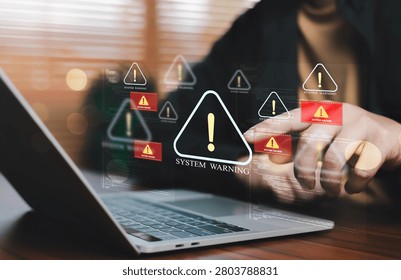 IT professional responding to critical system warning alerts on a laptop, illustrating cyber incident response, infrastructure monitoring, network defense, security operations, threat detection