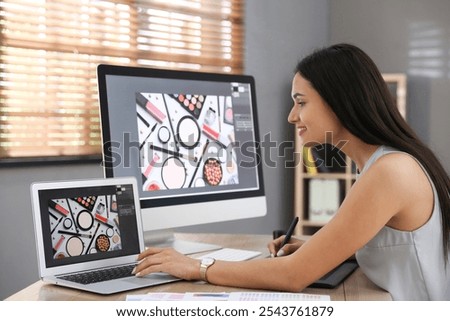 Professional retoucher working on computer in office