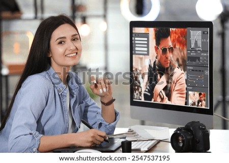 Professional retoucher working on computer in office