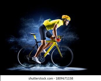 Professional road bicycle racer in action isoated on the black background