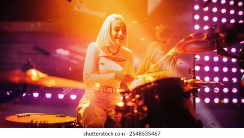 Professional Rock Musicians Performing a Live Set on Festival Stage, Playing Popular Rock Tracks Together with a Young Beautiful Female Drummer. Performance at a Festival with Falling Confetti - Powered by Shutterstock