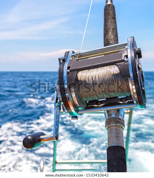 Ocean Fishing Reels And Rods With Grabbing Hand Stock Photo - Download  Image Now - Fishing, Fishing Industry, Yacht - iStock