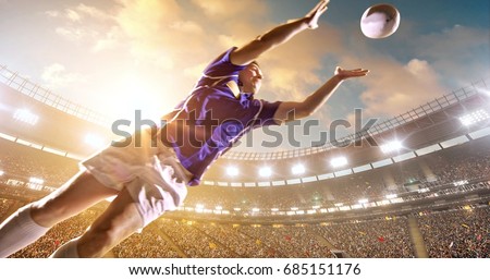 Professional rugby player jumps with a ball on a professional sports arena with bleaches full of people. Arena and people on it are made in 3D.
