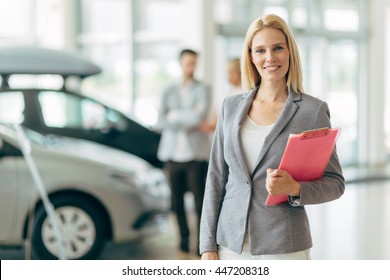 Professional Salesperson Working In Car Dealership