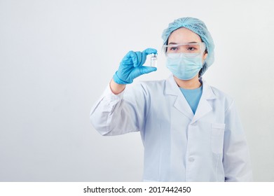 Professional scientist or doctor holding Covid-19 vaccine vial in hand of at laboratory for treatment with mask gloves and lab coat on white background. Health business and industry concept. - Powered by Shutterstock