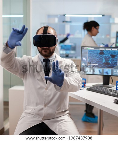 Professional scientist using medical inovation in lab wearing virtual reality glasses. Team of researchers working with equipment device, future, medicine, healthcare, professional, vision, simulator.