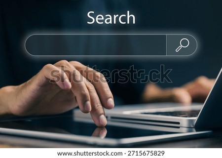 A professional searches on a digital interface using a laptop and tablet, representing online search engines, information retrieval, data discovery, SEO research, and digital marketing analysis.