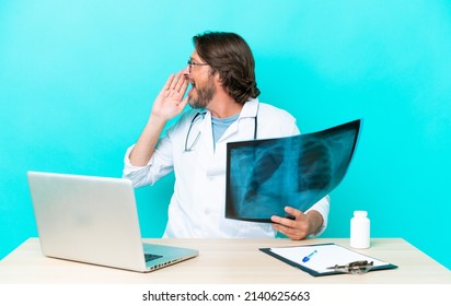 Professional senior dutch traumatologist in office shouting with mouth wide open to the side