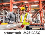 Professional senior engineer training, Two workers working, Technician supervisor man work with young engineer in steel metal industry manufacture factory plant.