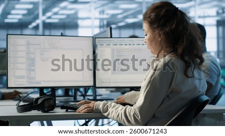 IT professional in server hub ensuring valuable data remains shielded from potential threats using PC. Employee safeguarding data center against unauthorized access and vulnerabilities, camera A