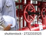 Professional service engineer preparing fire protection system maintenance at industrial workplace. Concept of fire safety inspection, emergency prevention, industrial safety management, engineering service, workplace protection, and equipment reliability.