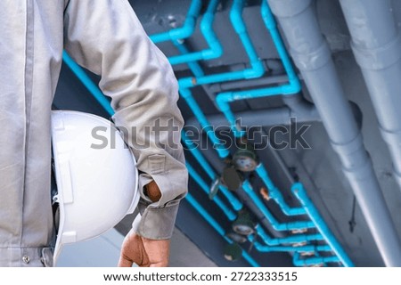 Professional service engineer preparing fire protection system maintenance at industrial workplace. Concept of fire safety inspection, emergency prevention, industrial safety management, engineering service, workplace protection, and equipment reliability.