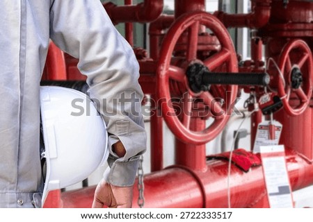 Professional service engineer preparing fire protection system maintenance at industrial workplace. Concept of fire safety inspection, emergency prevention, industrial safety management, engineering service, workplace protection, and equipment reliability.