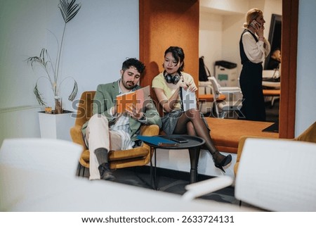 A professional setting showcasing teamwork, collaboration, and active communication among coworkers in a comfortable office lounge environment.