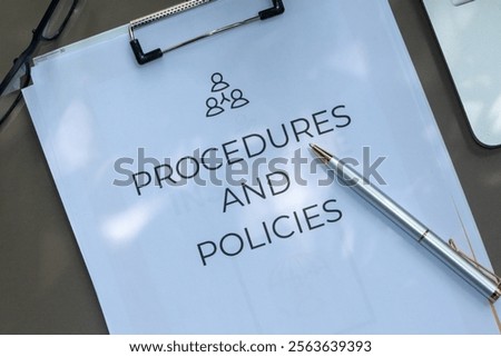 A professional setup featuring a clipboard with "Procedures and Policies" text and a pen for writing.