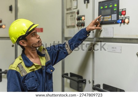 Professional ship engineer working below deck in the mechanical heart of a cargo vessel.