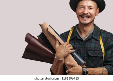 Professional shoes fashion designer chooses samples of leather for making custom made boots for client. Small business and shoe manufacturing Concept. - Powered by Shutterstock