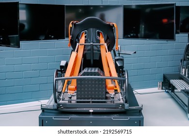 Professional Simulator And Trainer Of A Racing Driver With A Chair With Levers And Multiple Monitors