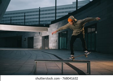 professional skateboarder balancing with board on bench - Powered by Shutterstock