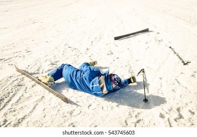 Professional Skier After Crash Accident On Skiing Resort Slope - Winter Sport Emergency Concept With Athlete Needing Help Assistance On Dramatic Trouble Situation - Warm Sunny Afternoon Color Tones