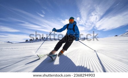 professional skier skiing on slopes in the Swiss alps towards the camera