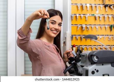 Professional skilled key cutter making door keys copies in locksmith. Young professional with different types of keys in locksmith