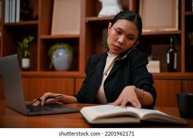Professional And Smart Asian Female Boss On The Phone Call With Her Assistant While Working On Her Tasks In The Office.
