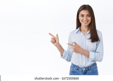 Professional smiling young woman help customer find where go, showing way, pointing finger left and grinning friendly, pleased to answer any questions as introduce new product, white background